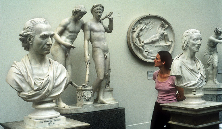 A woman looking at sculptures in the Victoria and Albert Museum in London