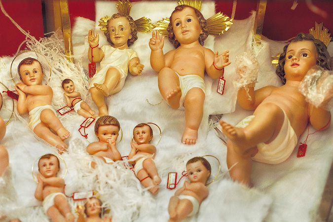 A shop window in Naples with baby dolls of Jesus for making creche scenes.