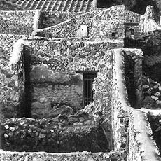 A view over ruined house walls in Pompeii.