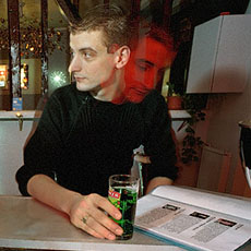 A man reading a booklet at the bar of Baxo, a restaurant on rue Juliette-Dodu.