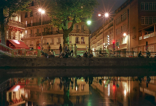 People hanging out on a summer night next to canal Saint-Martin.