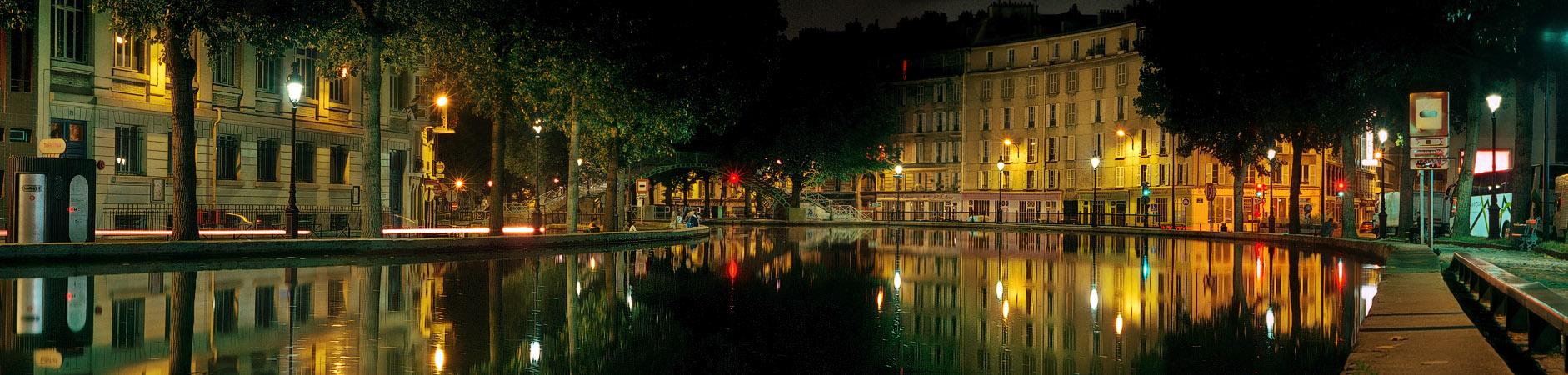A panorama of Bassin des Récollets on canal Saint-Martin at night.