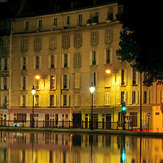 A panorama of Bassin des Récollets on canal Saint-Martin at night.