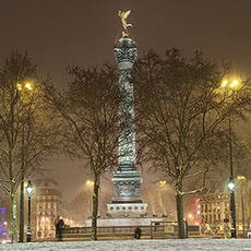 The Column of July in a snow storm at night.