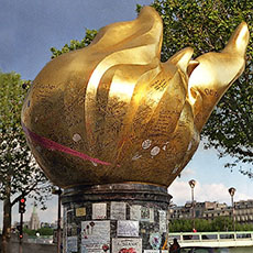 The scale model of New York’s Statue of Liberty flame next to the River Seine.