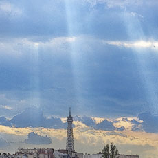 Shafts of light shining down on the Eiffel Tower.