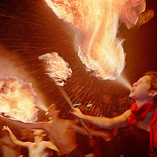 Fire eaters putting on a show in the Saint-Germain-des-Prés neighborhood at night.