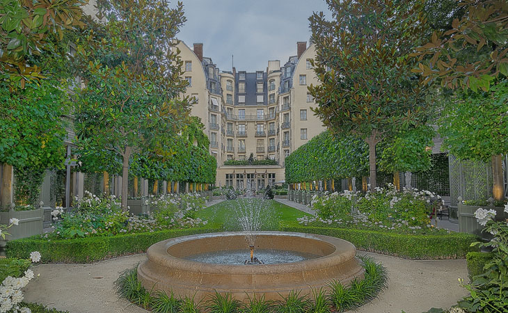 Trees, shrubs and a fountain in the Ritz Hotel’s garden.
