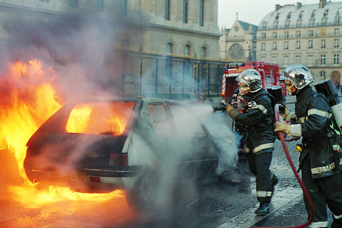 Une voiture en feu à côté du Louvre.