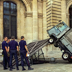 A cleaning truck perched on top of an access hatch at the Louvre Museum.