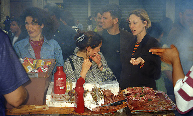 Three young women waiting for their Algerian merguez sausage during the Fête de la musique.