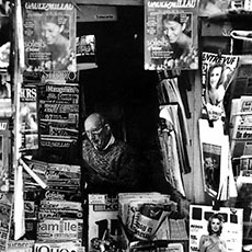 A vendor inside a newsstand on boulevard Montmartre.