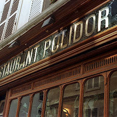 The sign and upper façade of the Crémerie Restaurant Polidor.