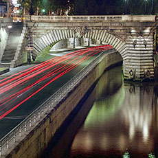 Cars driving on the Georges-Pompidou highway at night.