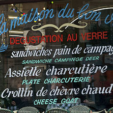Amusing translation mistakes on a Parisian restaurant window: Cheese goat.