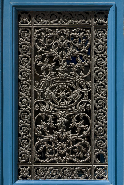 A wrought iron door grate on rue Vieille-du-Temple.