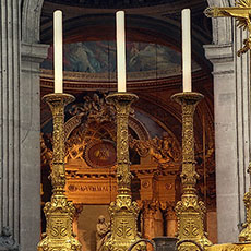 Three candle holders on the high altar inside Saint-Sulpice Church.