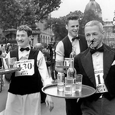Waiters and waitresses in the Waiters’ Race running on boulevard Sébastopol.