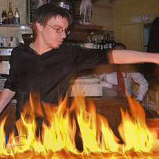 The barman at The Station setting the bar on fire with lighter fluid.