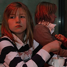 Two girls with their mother in the Café Montécao in Village Saint-Paul.