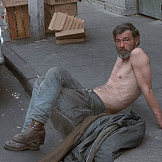 A homeless man on the sidewalk in Chinatown.