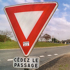A yield sign with a sticker reading “Boycot USA” near Maincy, France.