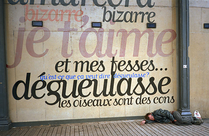 A homeless man sleeping in front of the MK2 cinéma in Paris.