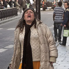 A homeless lady screaming next to Notre-Dame.