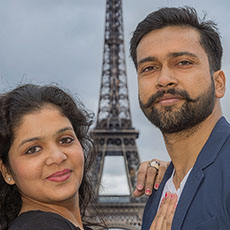 A portrait of Pulkit Goel and his wife in front of the Eiffel Tower.