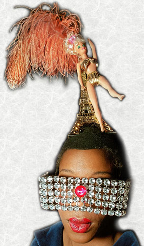 A model wearing a rhinestone sunglasses and an Eiffel Tower on her head in a fashion show in Paris.