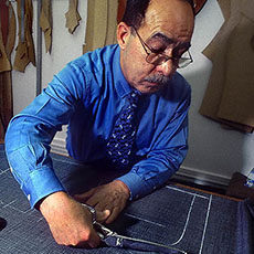 Vito cutting a pattern for a custom-made suit at Arnys