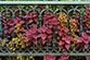 Coleus mixed in with a cast-iron fence