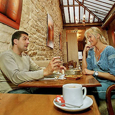 A man and a woman inside the café in Les Bains du Marais.