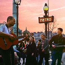 A guitarist and a bassist playing in place de la Bastille.