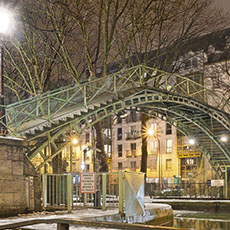 Passerelle de la Douane, a footbridge over canal Saint-Martin in a snowstorm.