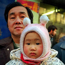A man holding his daughter in his arms during a Chinese New Year’s parade in Belleville.