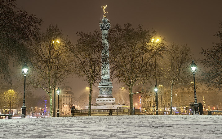 The Column of July in a snow storm at night.