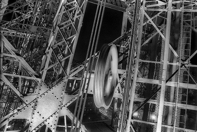 Iron girders, pulleys and cables inside the Eiffel Tower.