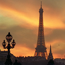 The Eiffel Tower, the American Church and pont Alexandre III at sunset.