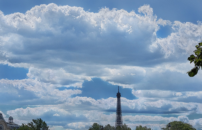 Des nuages flottant au-dessus de la Tour Eiffel, la vue depuis le quai des Tuileries.