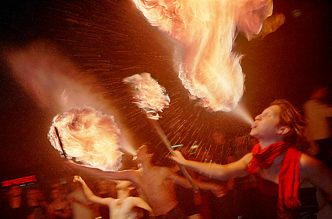 Fire eaters putting on a show in the Saint-Germain-des-Prés neighborhood at night.
