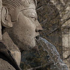 A sculpture of sphinx spitting water in the fontaine des Palmiers.