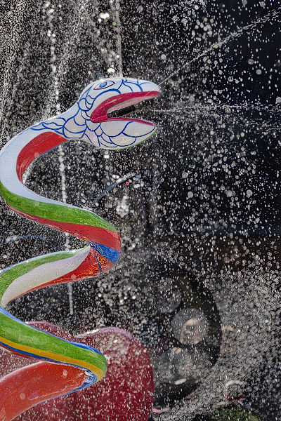 A sculpture of a snake by Niki de Saint Phalle spitting water in the Stravinsky Fountain.