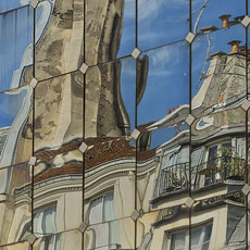 Reflections of buildings on rue Rambuteau in the windows of le Forum des Halles.