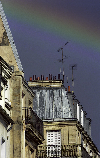 A rainbow above buildings on rue Berger.