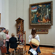 An artist creating a replica of a painting in the Louvre Museum.