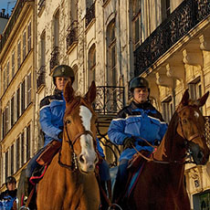 Three members of the Garde Républicaine riding horses on île Saint-Louis.