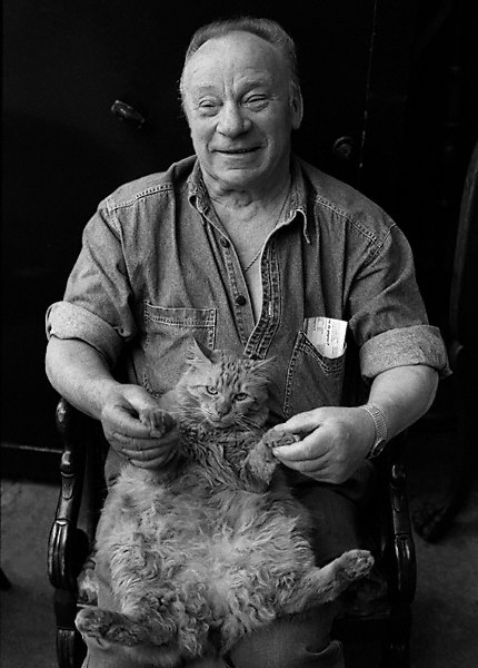 A furniture vendor with his cat at the flea markets at porte de Clignancourt.