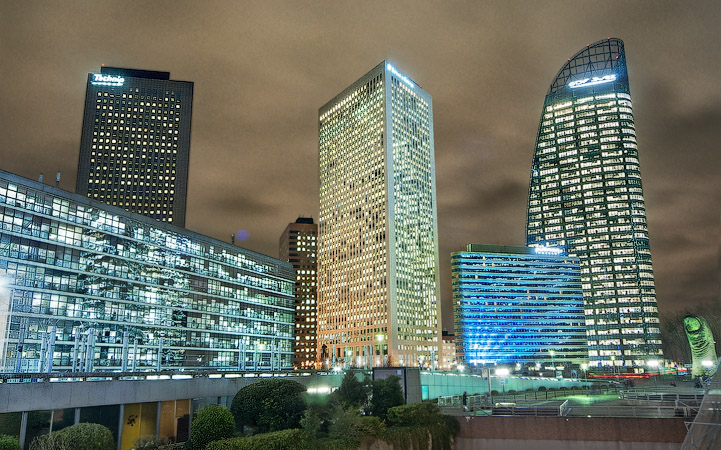 The Technip, Ernst & Young, Pullman Hotels and GDF Suez towers in the La Défense business district at night.