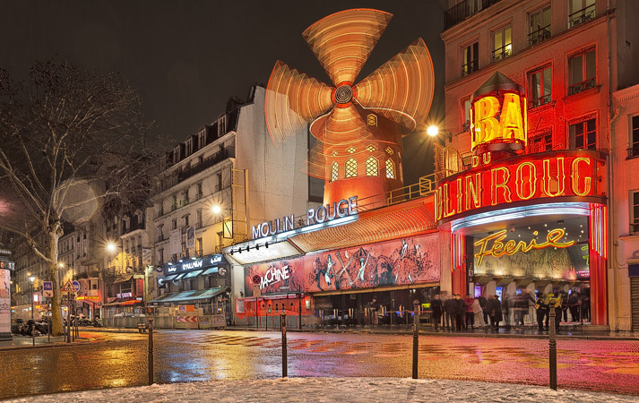 The Moulin Rouge in a snowstorm at night.